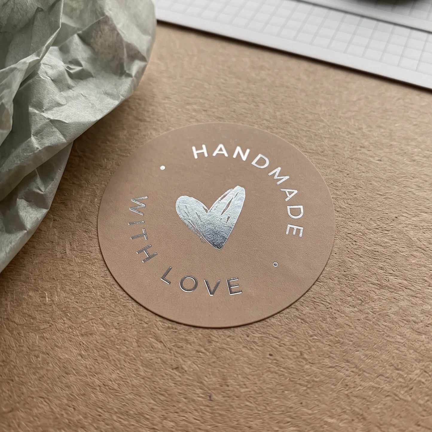 A hand-lettered scribbled heart label adding a maker detail to product bags.