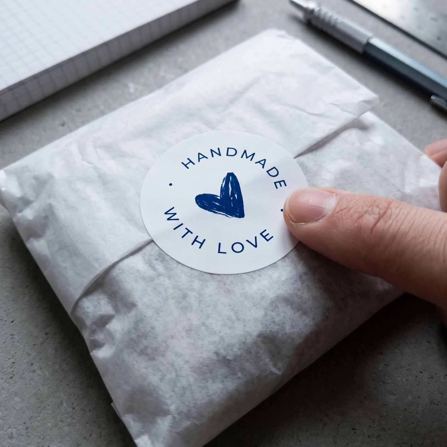 Round 2-inch packaging seal with a hand-lettered heart for online orders.