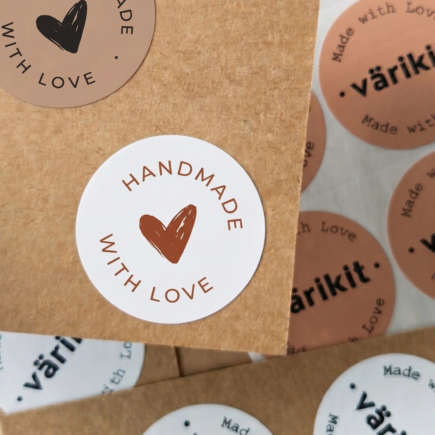 Stickers with 'Handmade with Love' and varikit brand name on a cardboard background
