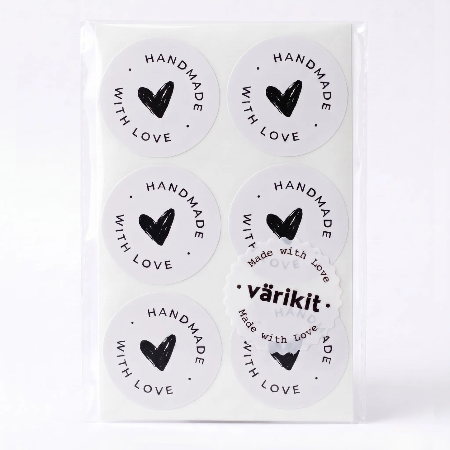 Handmade with love sticker with scribbled heart script design in white and black