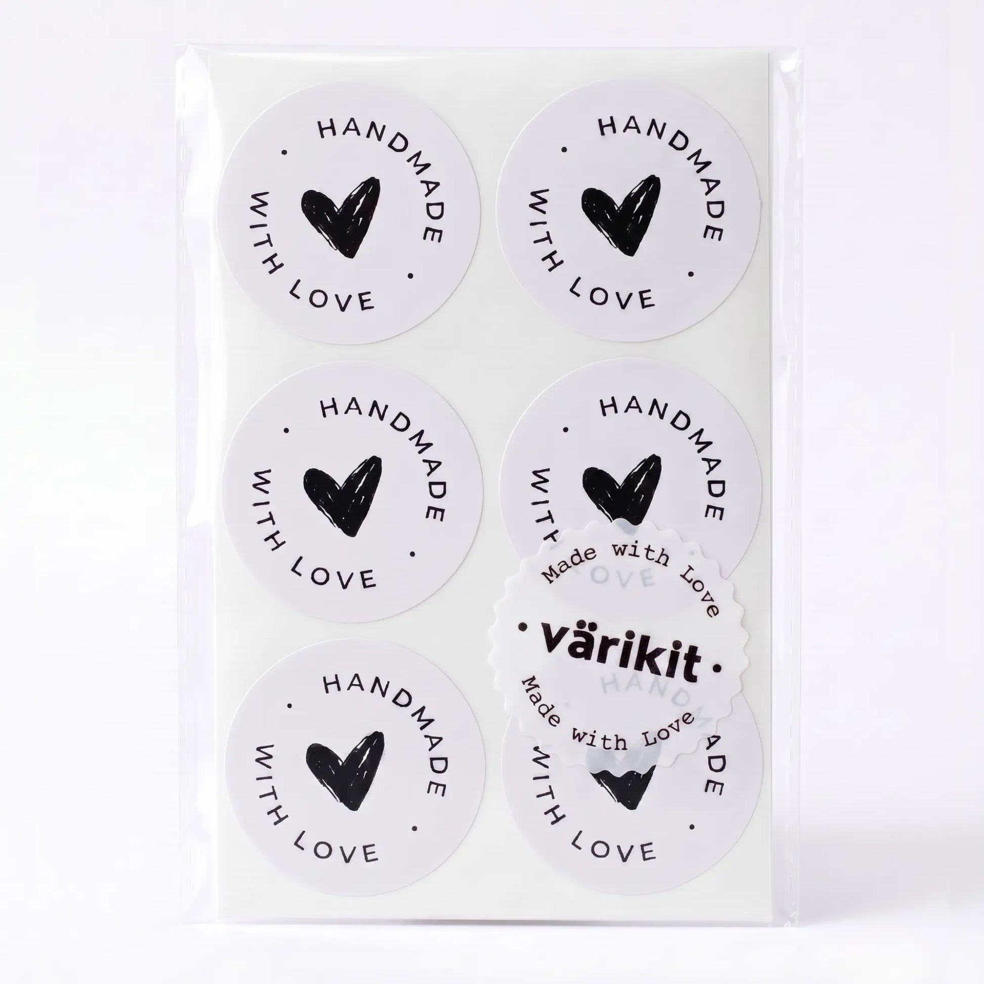 Handmade with love sticker with scribbled heart script design in white and black