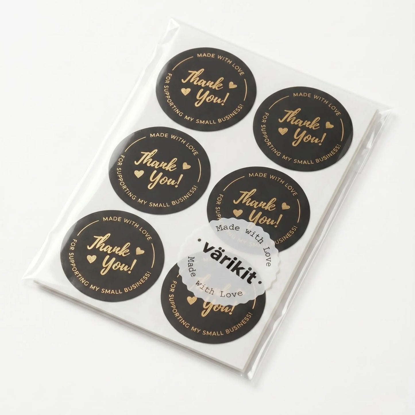 Pack of black and gold stickers with 'Thank you!' text, displayed in a clear plastic packaging.