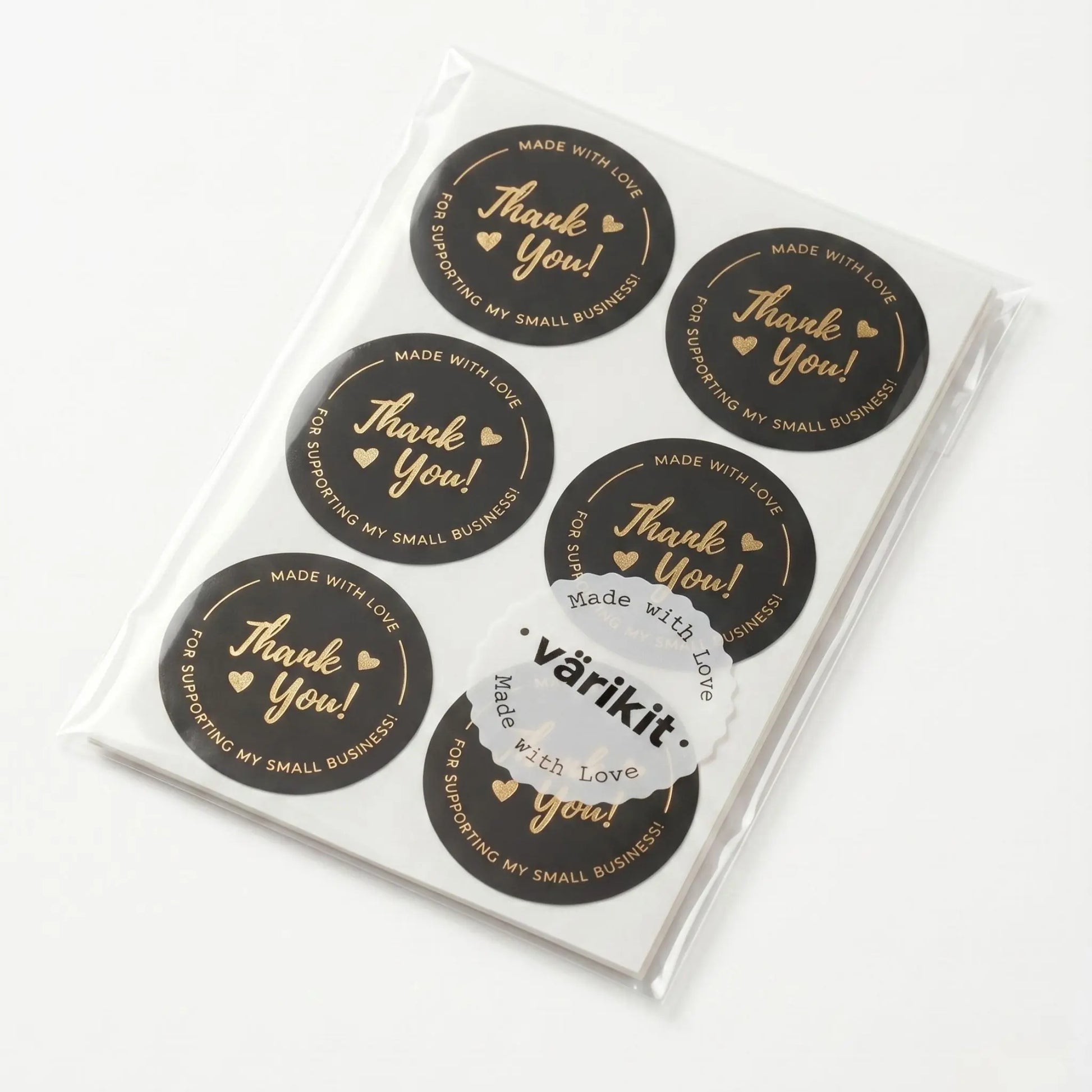 Pack of black and gold stickers with 'Thank you!' text, displayed in a clear plastic packaging.