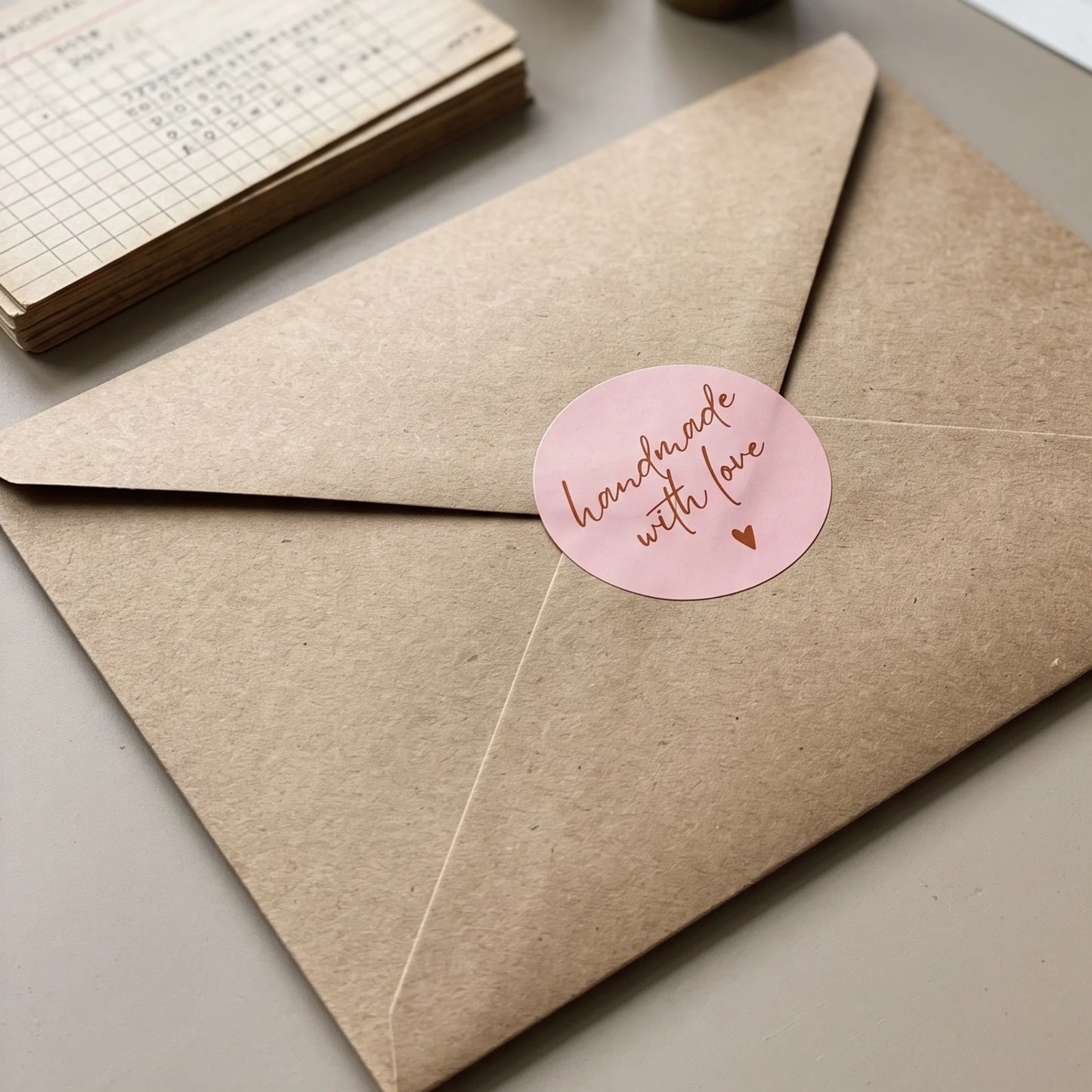 Handmade with Love in modern script, a packaging seal for online shipments.