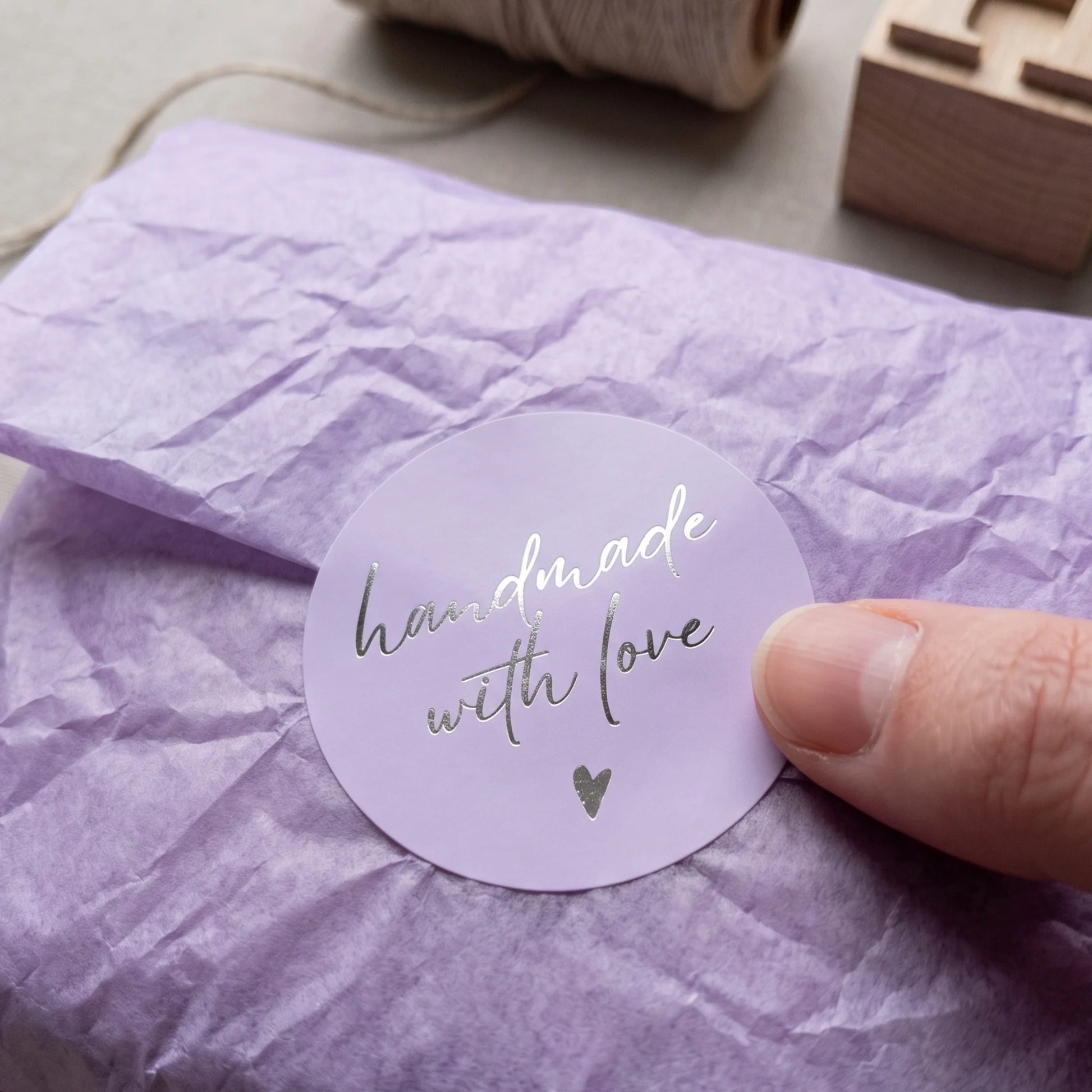 Complete handmade gift packaging with a stacked script lettering seal.