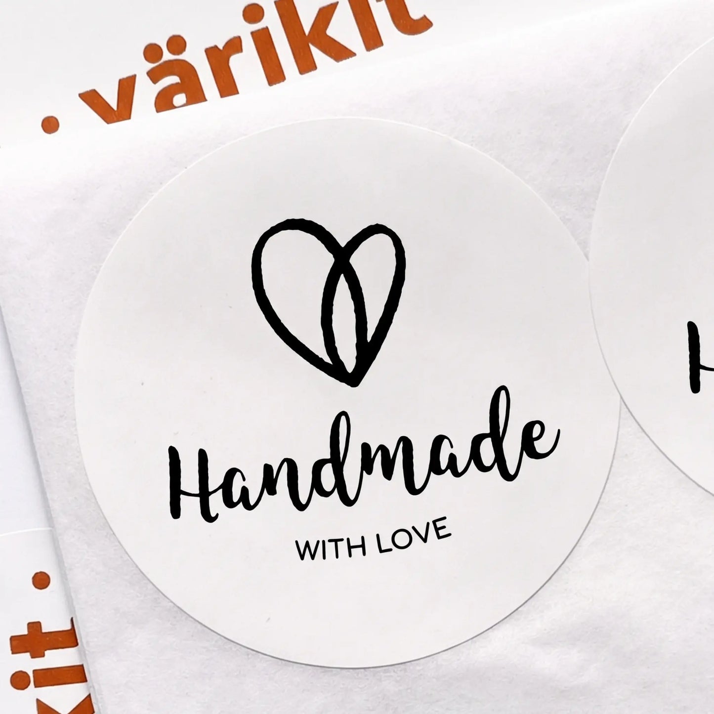 Round sticker with 'Handmade with Love' text and a heart symbol on a white background.