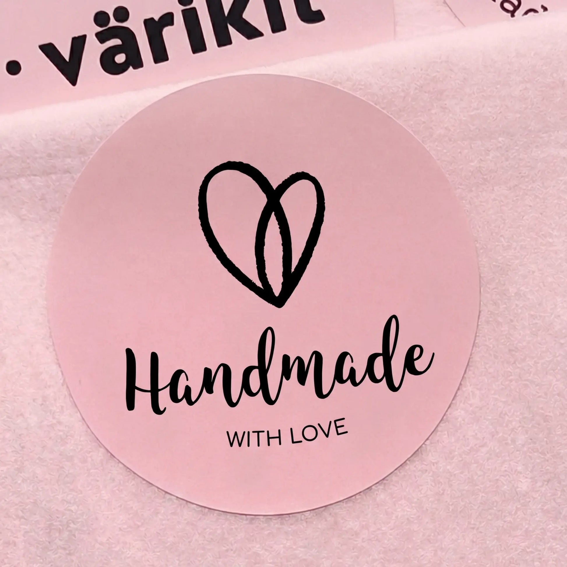 Round pink label with 'Handmade with Love' text and heart design on a pink background.