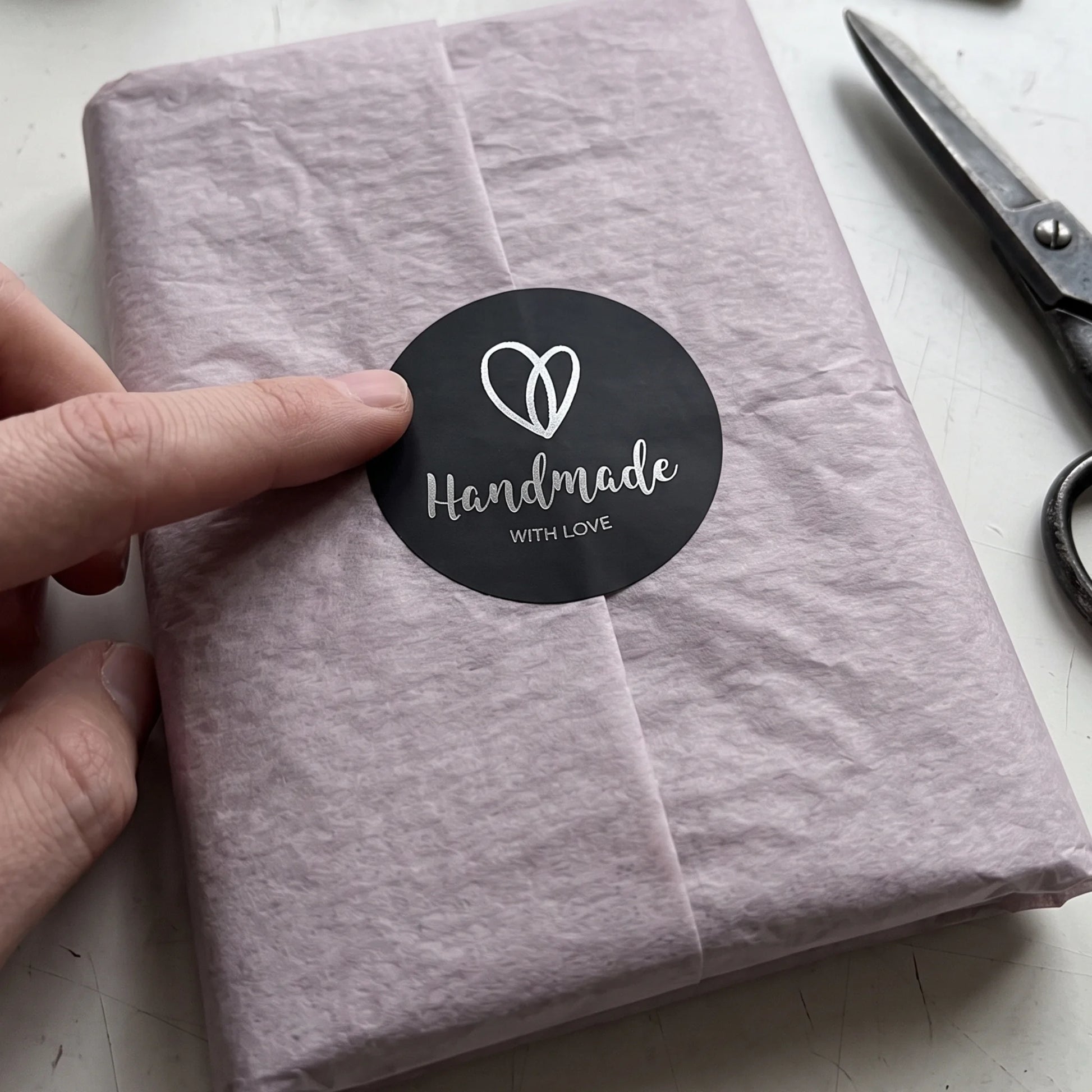 Handmade with Love in delicate script, a package seal for gift boxes.