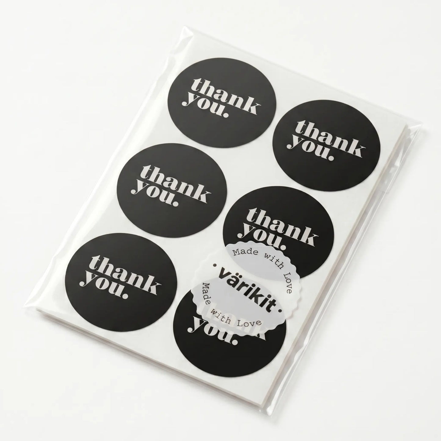 Pack of black 'thank you' stickers with a clear plastic sleeve on a white background