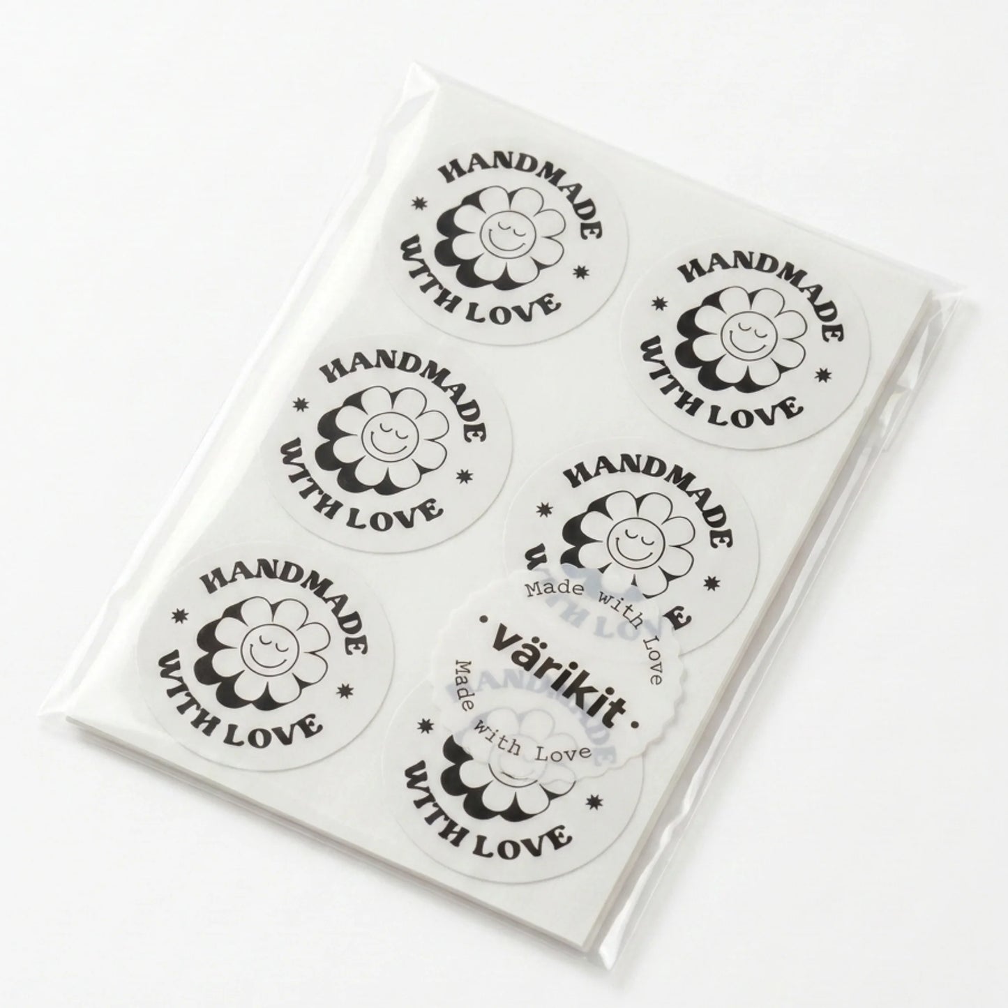 Round label with 'Handmade with Love' text and a flower design on a cardboard background.