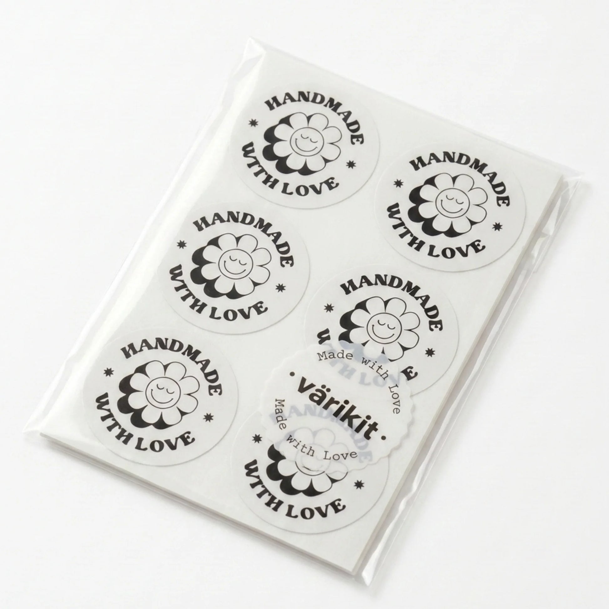 Round label with 'Handmade with Love' text and a flower design on a cardboard background.