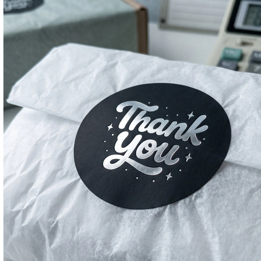 A Thank You sticker greeting small business customers as they open gift wraps.