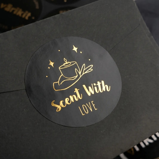 Black product packaging with a gold 'Scent With Love' label on a black background