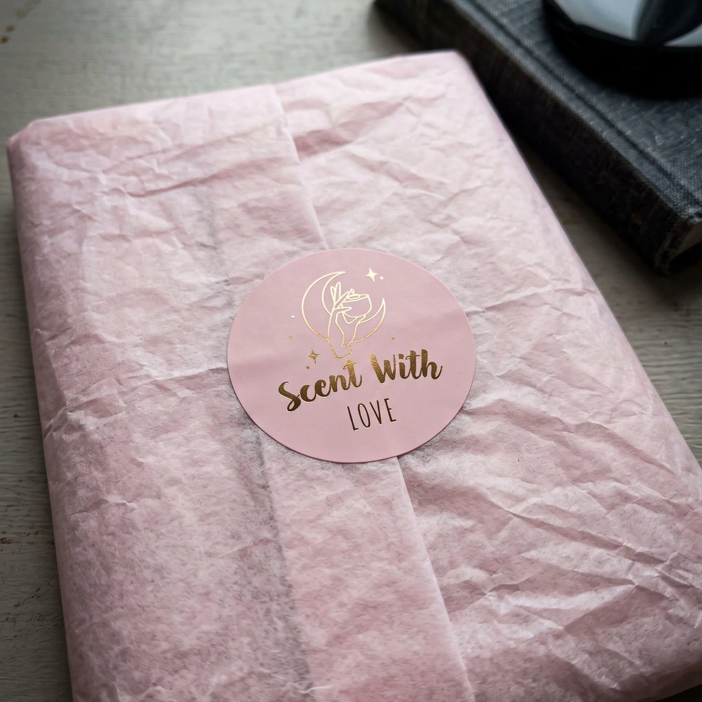 Scent With Love Mystic Candle Hand Varikit sticker reading 'Scent with Love' sealing folded beige tissue paper wrapping.