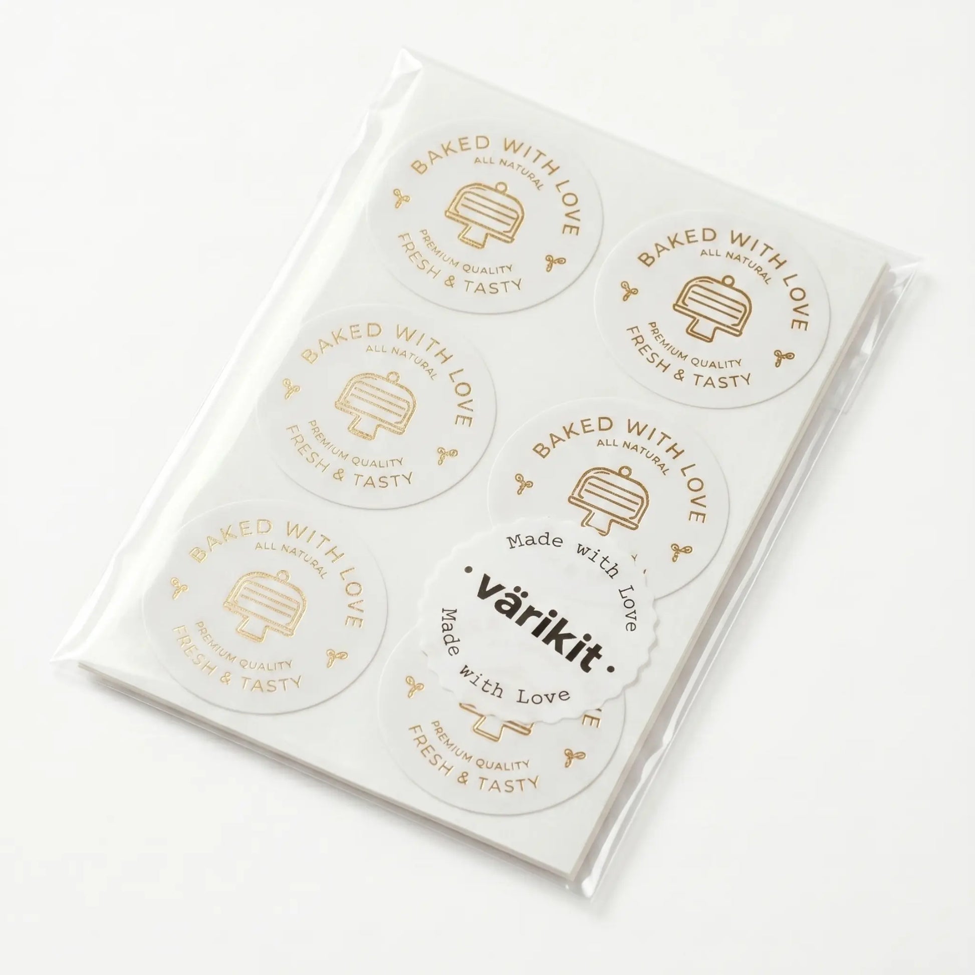 Pack of stickers with 'Baked with Love' gold foil text and 'varikit' branding on a white background