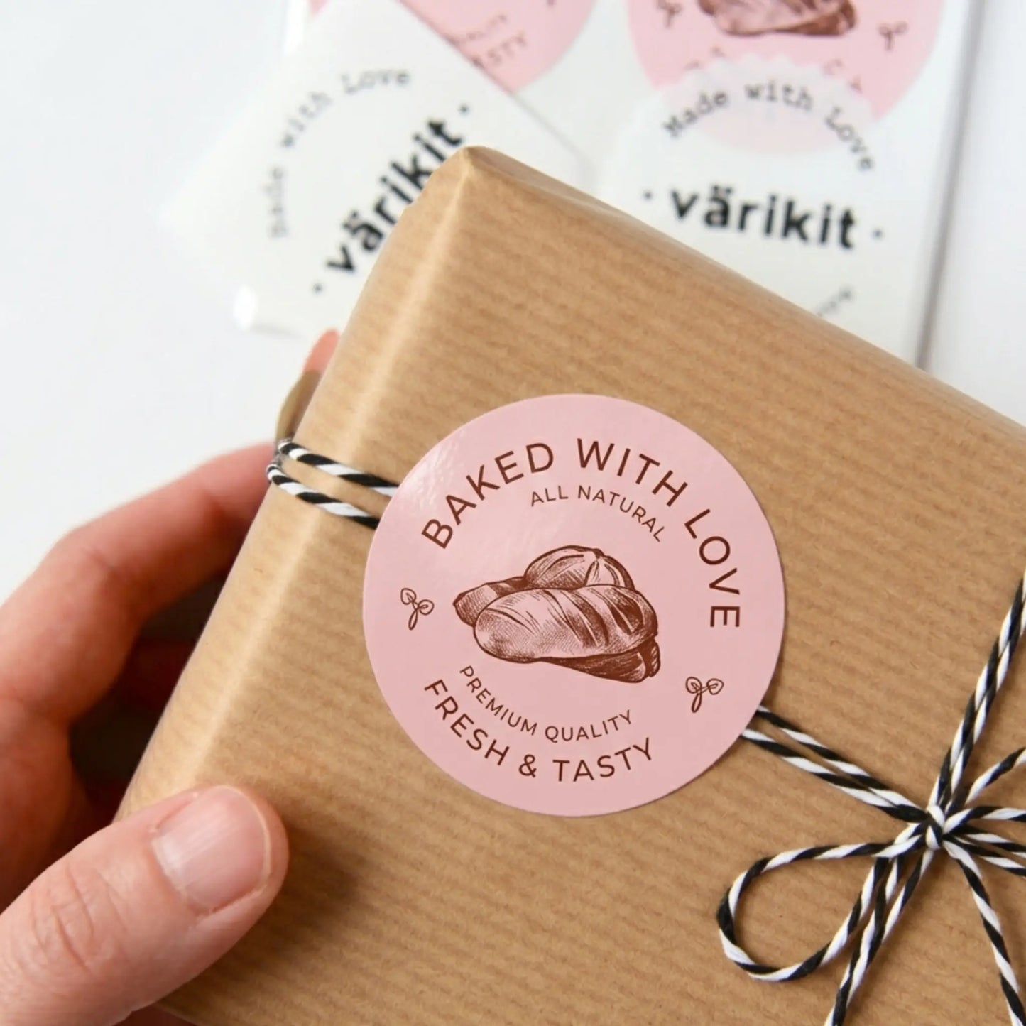 Gift box with 'Baked with Love' sticker and 'Värikit' branding in the background