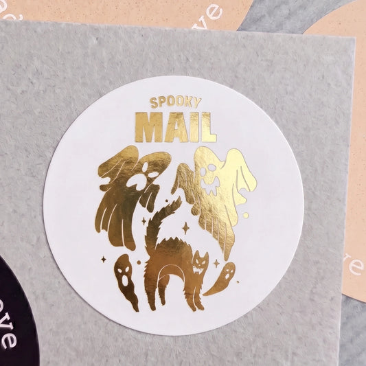 Playful Spooky Mail Startled Cat And Ghosts Varikit sticker reading 'SPOOKY MAIL' on a grey surface.