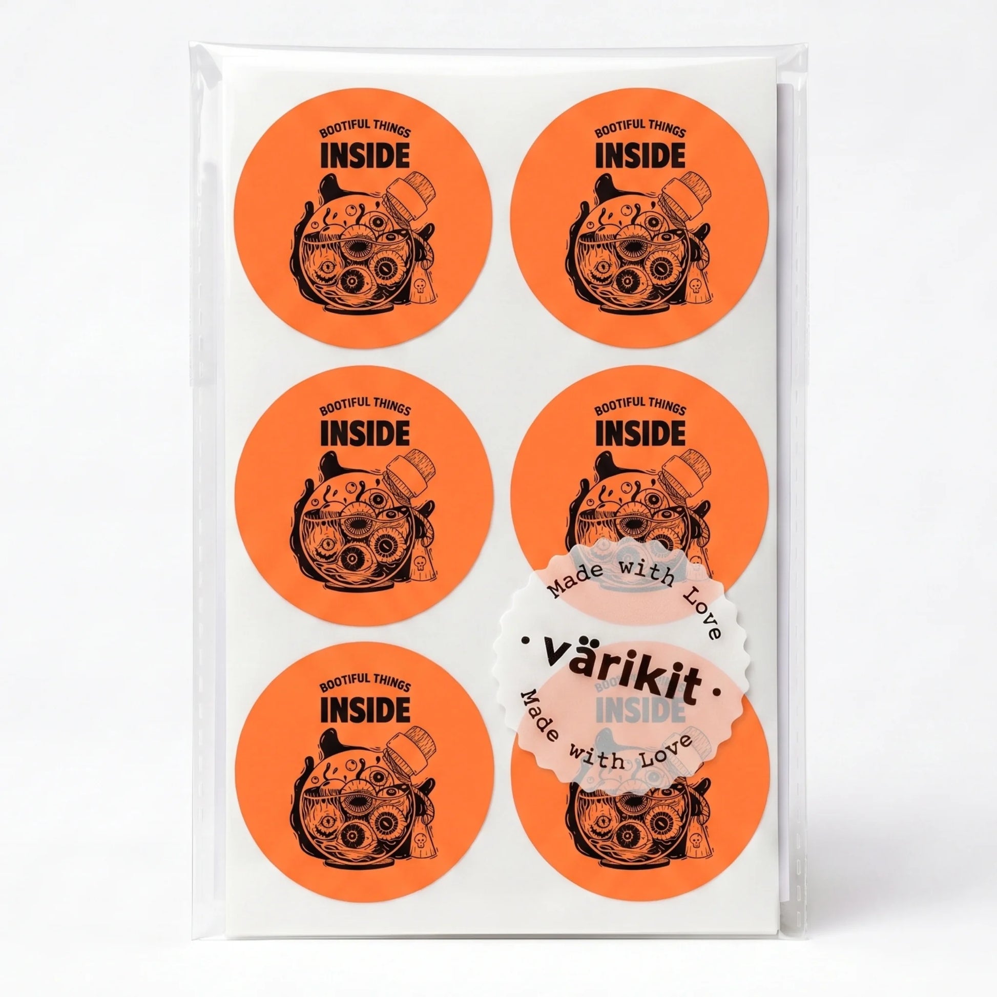 black ink on orange paper, 2-inch round spooky packaging labels, eyeball jar illustration.