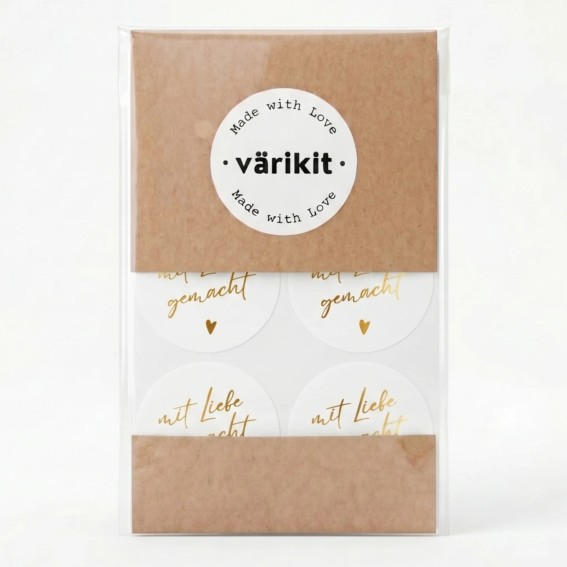 Kraft paper packaging with a white label and gold foil 'mit Liebe gemacht' text on a white background