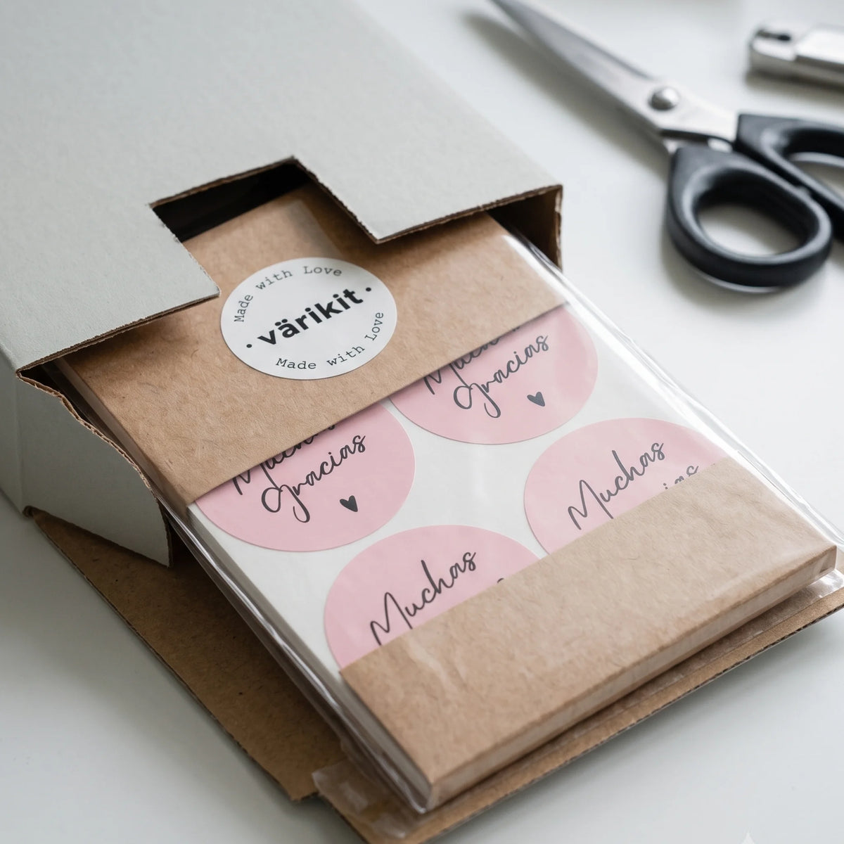 Muchas Gracias in modern script, a packaging sticker for closing gift boxes.